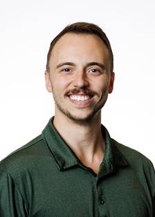 Chris Homa headshot; wearing a green polo shirt and smiling